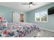 Bright bedroom features a ceiling fan, stylish window shutters, and sliding door entry to the bathroom at 912 N Shore Dr, Anna Maria, FL 34216