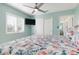 Bright bedroom boasts a sleek ceiling fan, flat-screen TV, and a large window for abundant natural light at 912 N Shore Dr, Anna Maria, FL 34216