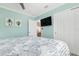 Comfortable bedroom with teal walls, large bed, ceiling fan, and closet with sliding doors at 912 N Shore Dr, Anna Maria, FL 34216