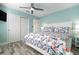 Well-lit bedroom with wood-look flooring, a comfortable bed, and ample storage with large sliding door closets at 912 N Shore Dr, Anna Maria, FL 34216