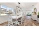 Bright dining room featuring a white table, modern chandelier, and view to living room at 912 N Shore Dr, Anna Maria, FL 34216