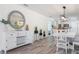 Dining room with modern light fixture and plenty of natural light at 912 N Shore Dr, Anna Maria, FL 34216