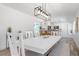 Bright dining room area with a bench and modern light fixture at 912 N Shore Dr, Anna Maria, FL 34216