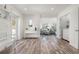 Bright entryway with wood-look floors that leads to the living area and laundry room at 912 N Shore Dr, Anna Maria, FL 34216