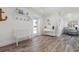 Bright entryway with wood-look floors, coat rack, and beachy decor at 912 N Shore Dr, Anna Maria, FL 34216