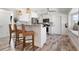 Modern kitchen bar with wicker stools and white cabinets at 912 N Shore Dr, Anna Maria, FL 34216