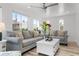 Bright living room with modern sofas, a ceiling fan, and shiplap accents at 912 N Shore Dr, Anna Maria, FL 34216