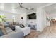 Bright living room with a modern sofa, shiplap accents, and a TV at 912 N Shore Dr, Anna Maria, FL 34216