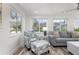 Bright living room with lots of windows, modern furniture, and wood-look floors at 912 N Shore Dr, Anna Maria, FL 34216