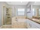 Relaxing bathroom featuring a soaking tub, separate shower, and granite countertops at 11330 80Th E St, Parrish, FL 34219