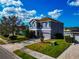 Two-story home featuring a blue exterior, well-manicured lawn, and a two-car garage at 11330 80Th E St, Parrish, FL 34219