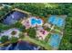 Overhead view of community amenities including a pool, playgrounds, tennis and basketball courts, and lush landscaping at 1314 Brambling Ct, Bradenton, FL 34212