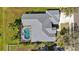Aerial view of house with screen enclosed pool and spa, lush landscaping and private backyard at 1314 Brambling Ct, Bradenton, FL 34212