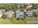 Aerial view of home showing pool, landscaping, and proximity to canal and neighboring properties at 1314 Brambling Ct, Bradenton, FL 34212