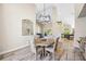 Dining area adjacent to living spaces, featuring modern lighting and wood-look flooring at 1314 Brambling Ct, Bradenton, FL 34212