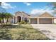 Charming single-story home featuring a three-car garage, manicured lawn and inviting curb appeal at 1314 Brambling Ct, Bradenton, FL 34212