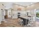 Spacious kitchen with granite counters, stainless steel appliances, an island with seating, and wood-look tile flooring at 1314 Brambling Ct, Bradenton, FL 34212