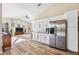 Open living area with ample natural light, high ceilings, and a built-in bar with a stainless steel refrigerator at 1314 Brambling Ct, Bradenton, FL 34212