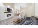 Open-concept living room featuring a fireplace, modern decor and seamless flow to dining area at 1314 Brambling Ct, Bradenton, FL 34212