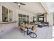 Expansive covered patio with an outdoor kitchen, a cozy seating area with a fire pit, and poolside bliss at 1314 Brambling Ct, Bradenton, FL 34212