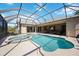 Screened lanai showcasing a pool and spa combination, accompanied by outdoor lounging and scenic backyard views at 1314 Brambling Ct, Bradenton, FL 34212