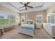 Bright bedroom with tray ceiling, bench seating, and ample natural light at 1407 Morning Sky Gln, Bradenton, FL 34208