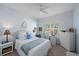 Nautical-themed bedroom with white wicker furniture, white bedding, blue accents and bright natural light at 1407 Morning Sky Gln, Bradenton, FL 34208