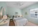 Light and airy bedroom with white wicker furniture, neutral walls, and bright window for natural light at 1407 Morning Sky Gln, Bradenton, FL 34208