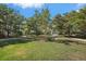 Beautiful community grounds feature mature trees and lovely landscaping with a wooden park bench at 1407 Morning Sky Gln, Bradenton, FL 34208