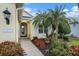 Inviting front entrance with a concrete walkway, attractive landscaping, and a view of the front door at 1407 Morning Sky Gln, Bradenton, FL 34208