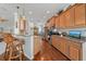 Well-equipped kitchen featuring wood cabinets, granite countertops, and stainless steel appliances at 1407 Morning Sky Gln, Bradenton, FL 34208