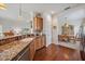 Bright kitchen featuring granite counters, stainless steel appliances, and hardwood flooring at 1407 Morning Sky Gln, Bradenton, FL 34208
