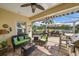 Comfortable lanai space with seating, lake view, grill, and awning for shade at 1407 Morning Sky Gln, Bradenton, FL 34208