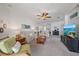 Spacious living room with neutral carpet, comfortable seating, and a large television for entertaining at 1407 Morning Sky Gln, Bradenton, FL 34208