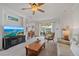 Open-concept living room with a ceiling fan, access to the lanai, and seamless flow to other living spaces at 1407 Morning Sky Gln, Bradenton, FL 34208