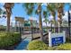 Community playground surrounded by tropical palm trees and bushes with a ' Corner' sign at 1407 Morning Sky Gln, Bradenton, FL 34208