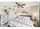 Bedroom with a ceiling fan, white sliding barn door, and a large bed with blue accents at 1515 Forrest Nelson Blvd # Q205, Port Charlotte, FL 33952