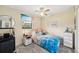 Cozy bedroom with ceiling fan, beach-themed decor, and a comfortable bed at 1515 Forrest Nelson Blvd # Q205, Port Charlotte, FL 33952