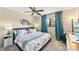 Bedroom with a ceiling fan, curtains, and a large bed with blue accents at 1515 Forrest Nelson Blvd # Q205, Port Charlotte, FL 33952