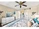 Bright bedroom with natural light, ceiling fan, a dresser with a TV, and decorative wall art at 1515 Forrest Nelson Blvd # Q205, Port Charlotte, FL 33952