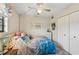 Comfortable bedroom with a ceiling fan, closet, and beach-themed accents at 1515 Forrest Nelson Blvd # Q205, Port Charlotte, FL 33952