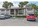 Exterior shot of the condo, showcasing manicured landscaping and reserved parking for residents and guests at 1515 Forrest Nelson Blvd # Q205, Port Charlotte, FL 33952