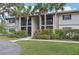 Inviting condo building featuring lush landscaping and mature palm trees at 1515 Forrest Nelson Blvd # Q205, Port Charlotte, FL 33952