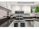 Modern kitchen features stainless steel appliances, breakfast bar, and plenty of storage space at 1515 Forrest Nelson Blvd # Q205, Port Charlotte, FL 33952