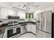 Modern kitchen with stainless steel appliances, white cabinets, granite countertops, and a marble tile floor at 1515 Forrest Nelson Blvd # Q205, Port Charlotte, FL 33952