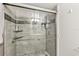 Modern walk-in shower with glass doors, mosaic tile accents, and brushed nickel hardware at 1515 Forrest Nelson Blvd # Q205, Port Charlotte, FL 33952