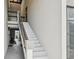 Staircase with a wooden handrail that leads to a condo at 1515 Forrest Nelson Blvd # Q205, Port Charlotte, FL 33952
