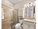 Bright bathroom featuring glass shower, vanity, and neutral tile flooring at 16741 Ellsworth Ave, Bradenton, FL 34202