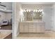 Bright bathroom with double vanity, stylish lighting, and a glimpse of the soaking tub at 16741 Ellsworth Ave, Bradenton, FL 34202