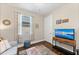Comfortable bedroom features a media center, TV, and bright window at 16741 Ellsworth Ave, Bradenton, FL 34202